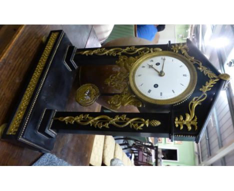 A black slate and ormolu mounted striking portico mantel clock, circa 1800, the architectural portico case with applied snake