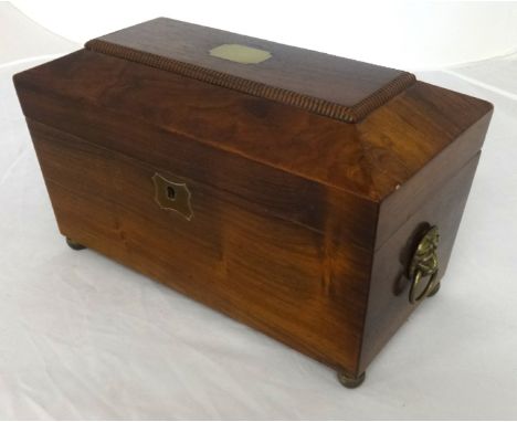 A 19th Century mahogany tea caddy, of sarcophagus shape, fitted with two tea boxes and a mixing bowl, width 31cm.