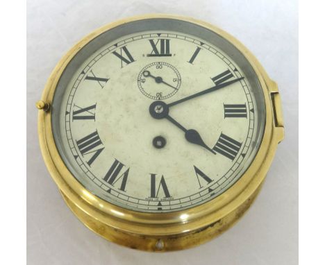 A brass cased ships clock with sub-second dial, 17cm diameter.