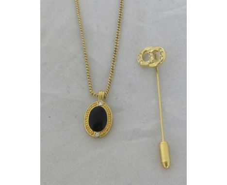 A Christian Dior oval black enamelled pendant and necklace and stick pin in original box.