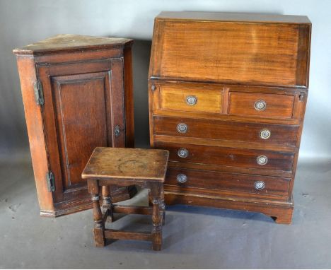A Mahogany Bureau, the fall front enclosing a fitted interior above two short and three long drawers with circular handles ra