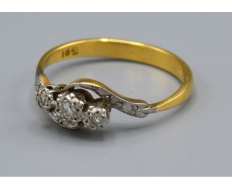 A 18ct Yellow Gold Diamond ring set with three diamonds within a crossover setting, Size R, 3.3 grams 