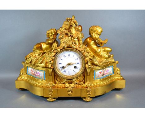 An Early 19th Century French Ormolu Mantle Clock by Raingo Freres Paris, the putti surmount with game to include fish, boar a