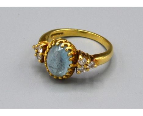 An 18ct. Gold Dress Ring with central cabochon moon stone flanked by six diamonds, claw set, ring size O, 6.5 gms 