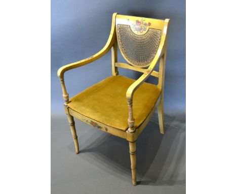 A Regency Painted Armchair, the partly caned back above a similar seat raised upon ring turned tapering legs 