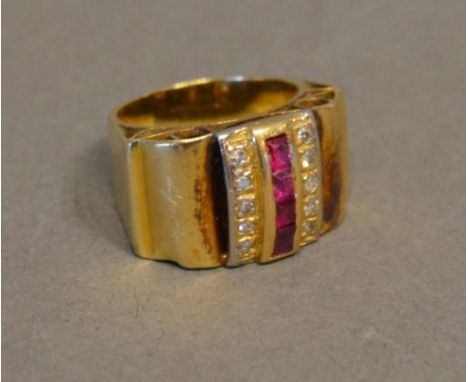 A Yellow Metal Cocktail Ring set with a band of rubies flanked by diamonds 