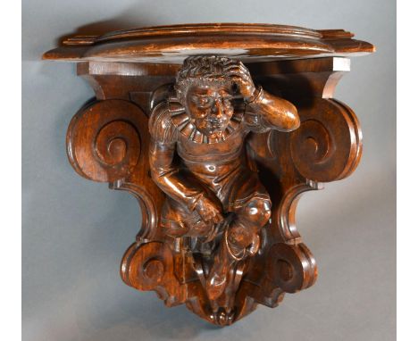 A Carved Oak Corner Wall Bracket of figural form 38 cms tall 