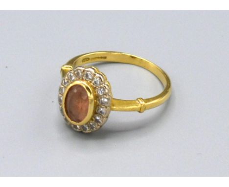 An 18ct. Gold Citrine and Diamond Cluster Ring with a central oval citrine surrounded by diamonds, ring size N, 4.5 gms 