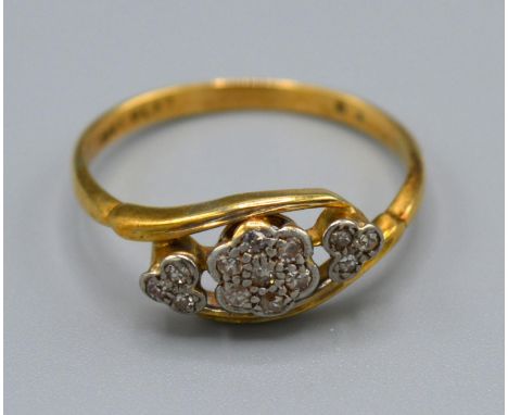 A 18ct Yellow Gold Diamond Ring set with three clusters of diamonds within a crossover setting, size P, 2.5 grams 