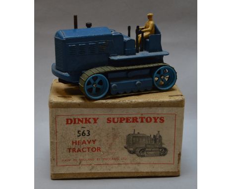 A boxed Dinky Toys diecast model, 563 Heavy Tractor, a scarce variant of this model in dark blue with mid blue rollers and gr