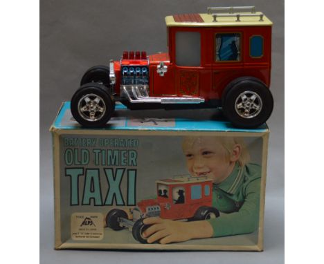 A boxed Alps (Japan) plastic and tinplate battery operated 'Old Timer Taxi', untested with some signs of damage and repairs i