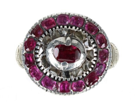 Antique gold backed ruby and diamond oval cluster ring, white metal rub-over set rubies and diamonds with an engraved yellow 