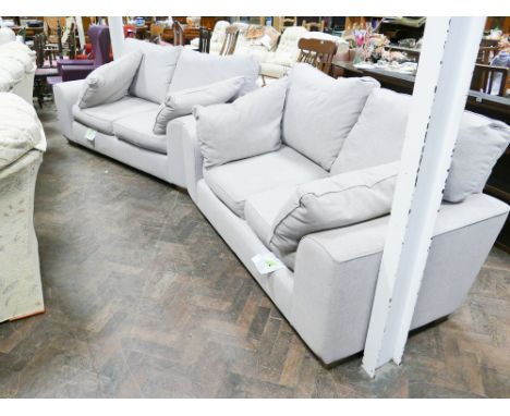 Pair of modern oatmeal chenille 2 seater sofas comprising large 2 seater and smaller 2 seater sofa 