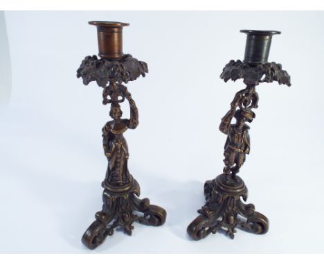 Pair of figural bronze candlesticks in the medieval style, raised on pierced Rococo bases.  25cm tall 