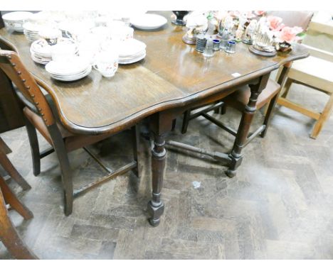 1930's dark oak drop leaf gateleg dining table and four matching rexine covered panel back dining chairs 