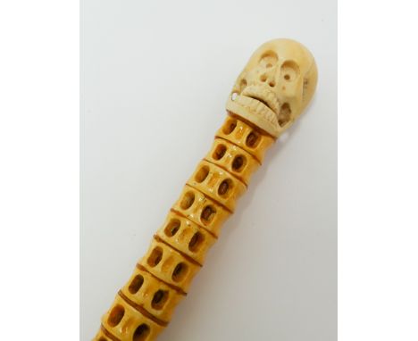Whalebone and carved ivory skull mounted swagger stick 51cm long 