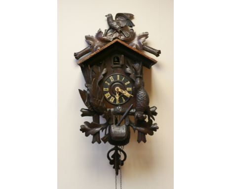 19th century Black Forest cuckoo clock decorated with dead game and bird over 