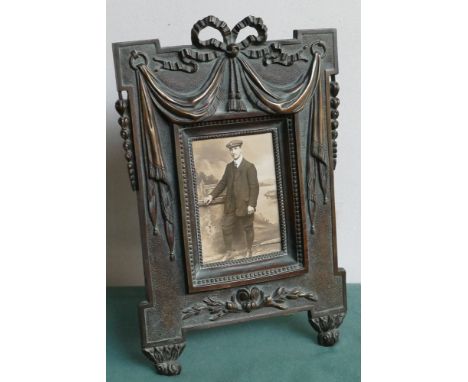 French bronze photograph frame with vintage photograph of a dashing young man.  Easel photograph frame stands 35cm high 