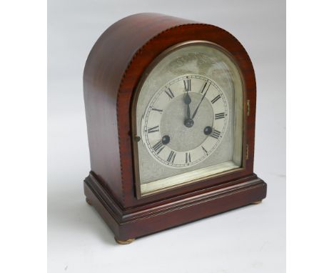 Edwardian striking mantel clock with arched silver dial in mahogany case 