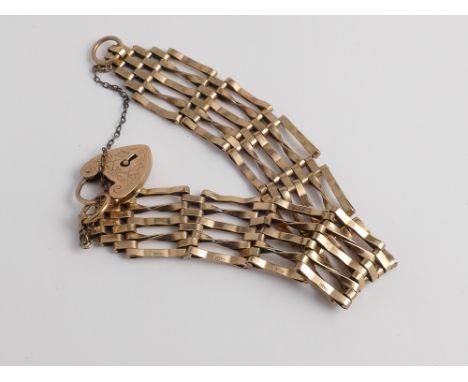 9ct yellow gold gate bracelet with heart shape padlock fastening and safety chain.  Gross weight 17g