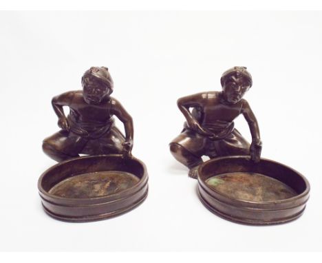 Pair of  bronze figures of seated Chinese merchants with a cauldron, each measuring 10cm high approx      Condition - one has