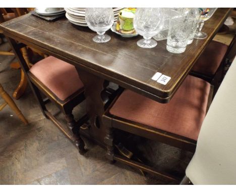 Dark oak Ercol refectory style drawer leaf dining table and four matching antique style dining chairs upholstered in blush pi