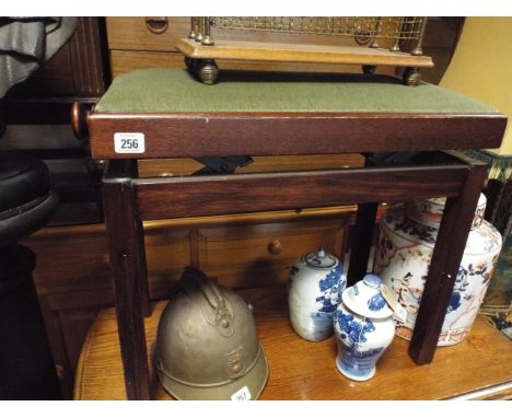 Adjustable mahogany framed piano stool with green upholstered top
