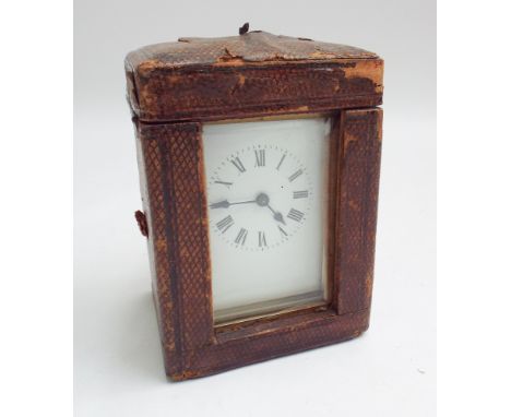Brass and glass cased carriage clock with white enamel face complete with leather travelling case 15cm high including handle 
