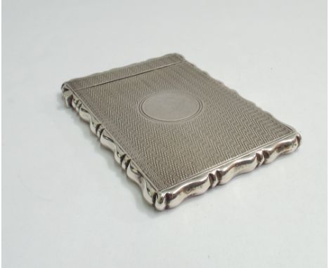 Late 19th century silver card case with shaped rectangular edge and engine turned decoration.  Birmingham 1899.  9.5 x 6.5cm 