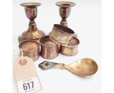 Pair of 1930's short silver candlesticks weighted bases 9.5cm high, 4 silver napkin rings and silver gilt and enamel decorate