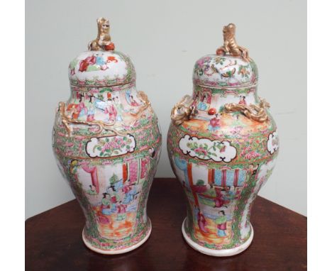 Pair of 19th century Canotonese porcelain vases, decorated with famille rose pallette depicting figures, birds and flowers wi