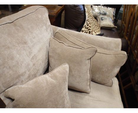 2 seater settee with loose cushions in fawn covering and a matching foot stool 