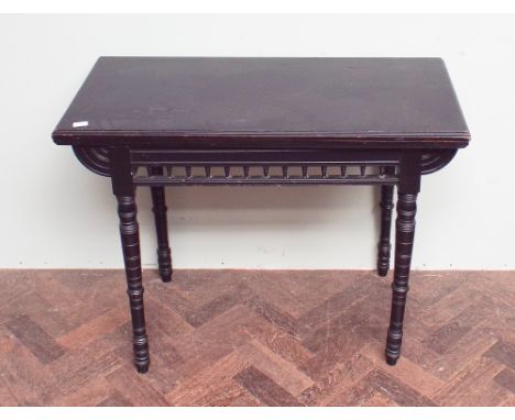 Edwardian ebonised folding top card table standing on turned legs with bobbin turned fret panels 3' wide 