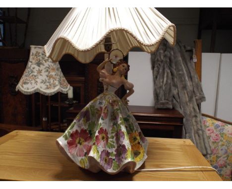 Large porcelain table lamp of a dancing girl with floral dress and cream shade 