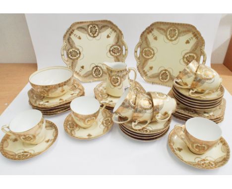 Noritake Japanese bone china tea service - 8 place settings decorated with gilt flowers on an ivory ground 