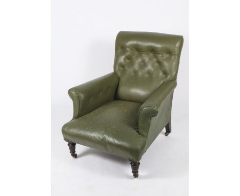 A GREEN LEATHER UPHOLSTERED BUTTON BACK ARMCHAIR standing on turned front legs and brass feet and castors 