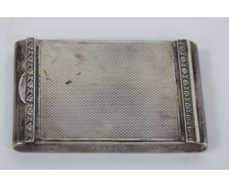 A RECTANGULAR SILVERED COMPACT with engine turned decoration to the lid, 7.7cm wide