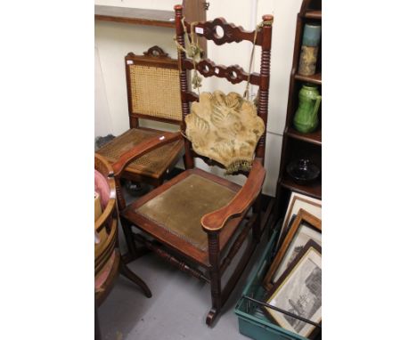 A ROCKING CHAIR with bobbin turned supports to the horizontal splats and open arms with turned stretchers 66cm wide together 