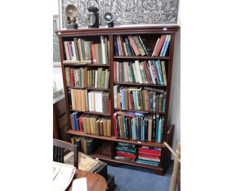 A MAHOGANY FLOOR STANDING OPEN BOOKCASE with two sets of adjustable shelves above recesses beneath, all standing on bracket f