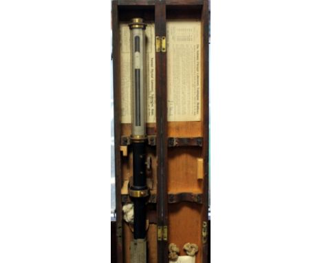 A MARINE BAROMETER of stick form by Negretti & Zambra, London complete with gimble and mounting bracket and in a fitted case 