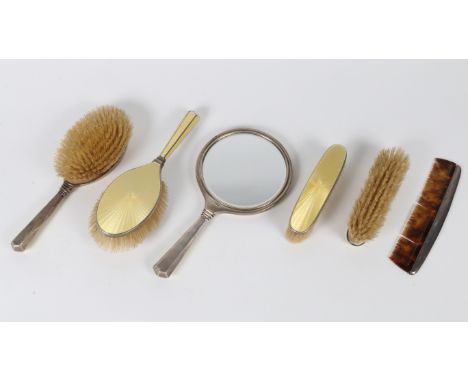 A SILVER YELLOW ENAMEL AND ENGINE TURNED BACKED DRESSING TABLE SET with hand mirror, two hairbrushes and two clothes brushes 