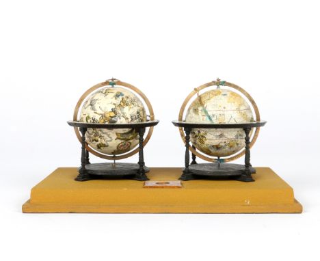 A PAIR OF MODEL TERRESTRIAL AND CELESTIAL GLOBES, on black stained oak stands mounted with a small compass under a perspex ca