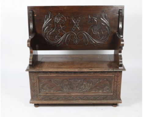 A CHIP CARVED OAK MONK'S BENCH with adjustable back and box base, 108cm wide