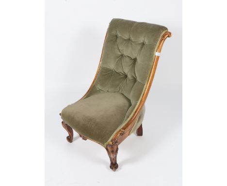 A VICTORIAN MAHOGANY BUTTON BACKED SLIPPER CHAIR with scroll carved frame and cabriole legs, 53cm wide