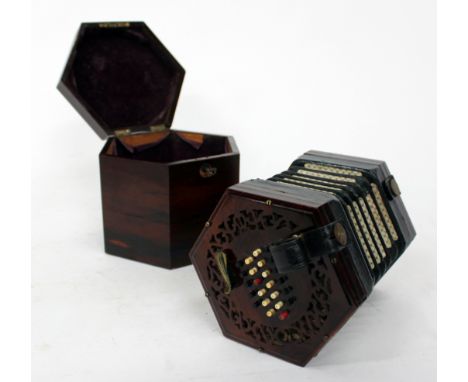 AN ANTIQUE, POSSIBLY 19TH CENTURY ROSEWOOD 48 BUTTON CONCERTINA with decoratively pierced end panels, unsigned, complete with