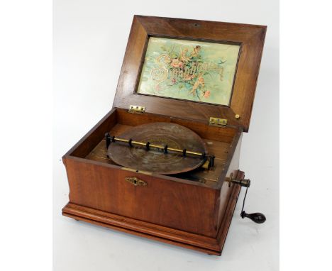 A CONTINENTAL WALNUT CASED SYMPHONION with retailers label for H Boyd & Co., Newcastle, playing 10.5 inch discs and complete 