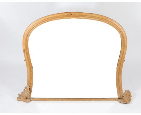 A STRIPPED PINE OVERMANTEL MIRROR of shaped outline with carved acanthus leaf decorated bracket supports, 130cm wide x 98cm h