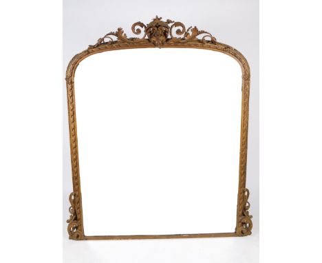 A VICTORIAN GILT FRAMED OVERMANTEL MIRROR with scrolling crest and bracket supports surrounding the arching mirror plate, 153