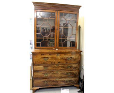 A GEORGE III MAHOGANY SECRETAIRE CHEST with later astragal glazed bookcase above , the secretaire drawer opening to reveal pi