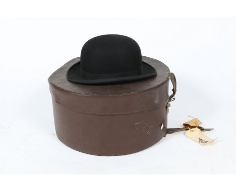 AN OLD TIN TRUNK together with a pair of black leather riding boots, a further single boot and a carved wooden sculpture of a